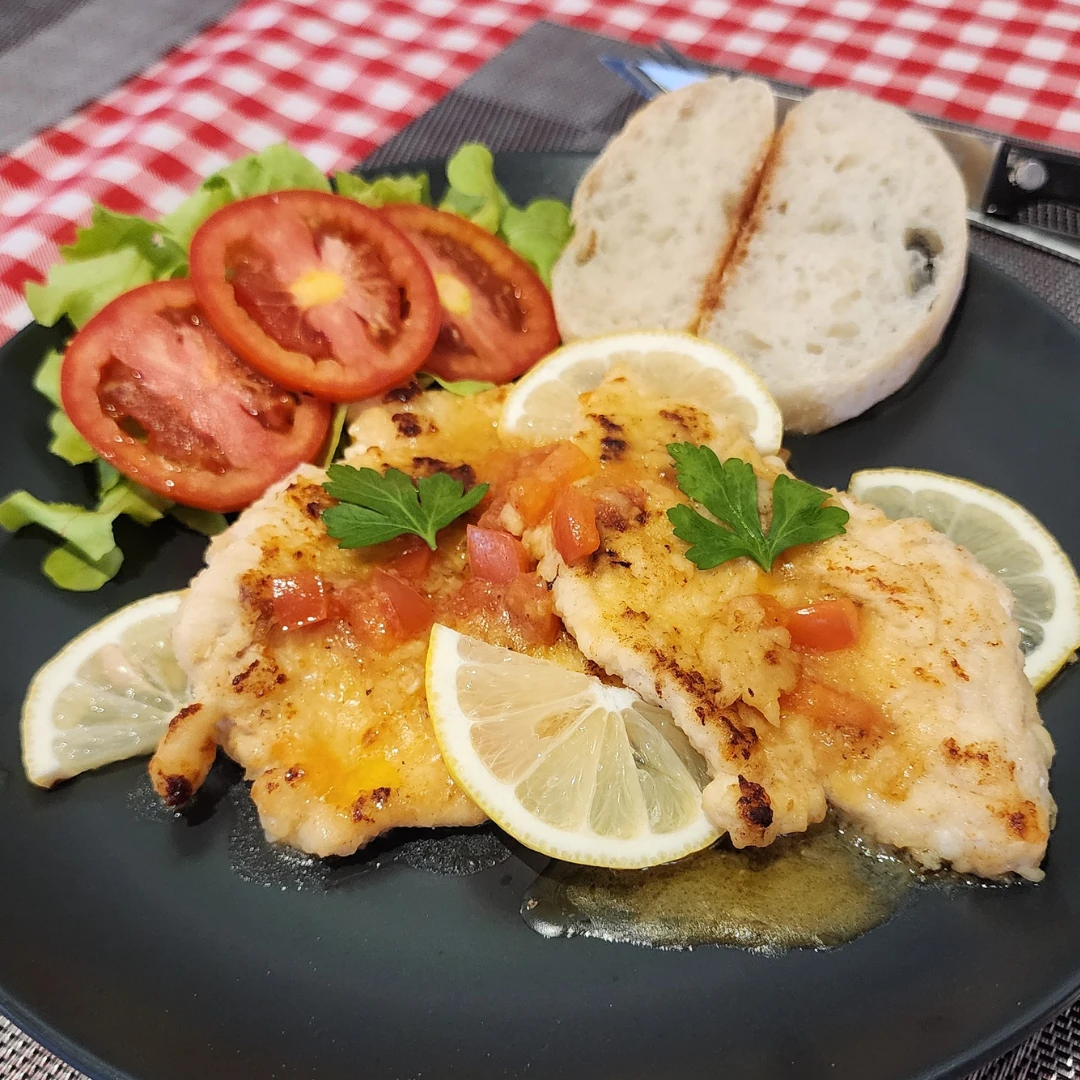 Chicken escalopes with lemon sauce, side salad and ciabatta